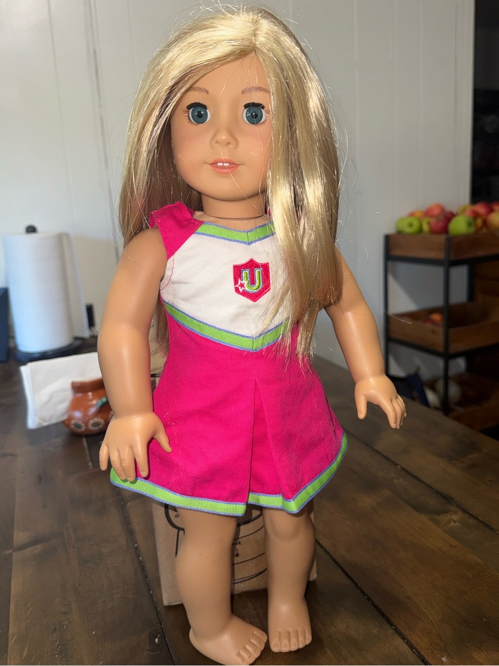 aAmerican Girl Truly Me doll#100 wearing a retired Campus Cheeroutfit from 2011.